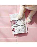 Merlins 100% Freeze Dried Salmon Powder on a pink background, with a cat's paw on the pouch.