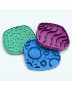 Three West Paw Feast Mats, one Waves in Tropic Red, one Marine Blue Bubbles, and the reverse of a Green Kelp Bubbles.